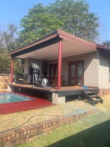 a small house with a patio and a swimming pool at Tucked away with a pool view in White River