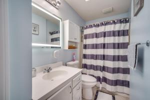 a bathroom with a sink and a toilet and a mirror at King Bed with Pool Table in Chicopee +37 photos