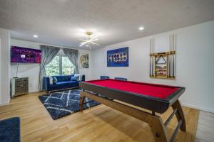 a living room with a pool table in it at King Bed with Pool Table in Chicopee
