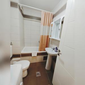 a bathroom with a toilet and a sink and a tub at Apartman Luna lukavica in Lukavica +6 photos