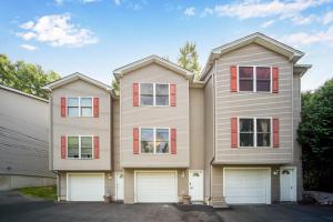 a house with two white garage doors at King Bed with Pool Table in Chicopee