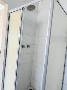 a shower with a glass door in a bathroom at Goshen in Johannesburg +11 photos