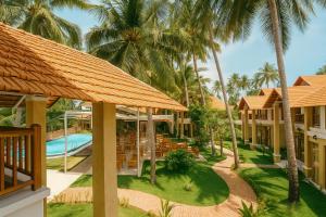 an aerial view of a resort with palm trees at Coconut Garden Mui Ne in Mui Ne