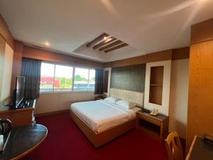 Ένα ή περισσότερα κρεβάτια σε δωμάτιο στο The Rich Hotel Rama 5