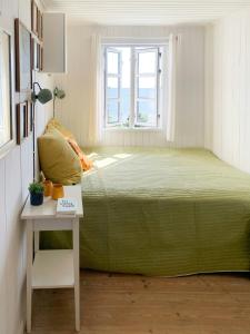 a bedroom with a large bed and a window at Beachfront House At Hølken Beach in Odder