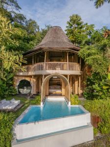 a house with a pool in front of a building at Eco Six Bali in Tampaksiring +120 photos
