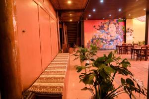 a room with a table and a painting on the wall at Anlani homestay in Ha Giang