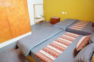 a bedroom with two beds and a mirror at Anlani homestay in Ha Giang