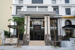 a white building with the entrance to a store at MT Collection Hotel Ha Long in Ha Long
