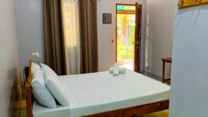 Ένα ή περισσότερα κρεβάτια σε δωμάτιο στο The Nook by GreenPark