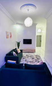 a living room with a blue couch and a tv at إقامة classi in Nouakchott