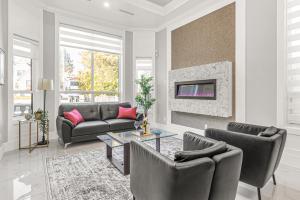 a living room with a couch and a table at 8BR New Spacious Home White Rock HVAC Free Parking in Surrey