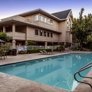 a house with a swimming pool in front of a house at RiverPointe Napa Valley Resort in Napa