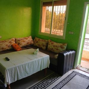 a living room with a couch and a table at Appartement Design Prés du Stade My Abdellah in Temara