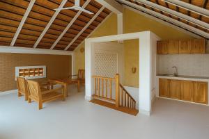 a kitchen and dining room with a table and a counter at Coconut Garden Mui Ne in Mui Ne