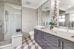 a bathroom with a sink and a toilet and a shower at 8BR New Spacious Home White Rock HVAC Free Parking in Surrey +47 photos