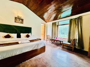 Un dormitorio con una cama grande y una ventana en Hotel Inn Way #Near Beas River, en Manali