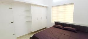 a bedroom with a bed and a large window at Heaven Cloud Stay Hub Attappadi in Attappādi