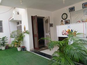 a room with a door and plants in it at Trans Varuna Inn in Varanasi