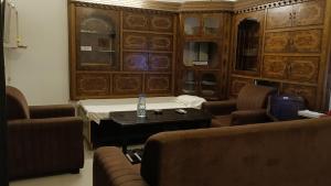 a living room with chairs and a table with a bottle on it at Trans Varuna Inn in Varanasi