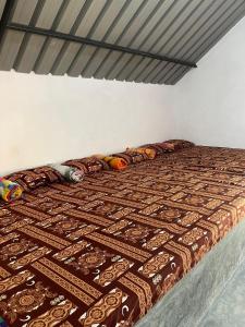 een bed in een kamer met een deken erop bij Royal Mountain Edge ,Knuckles in Rangala