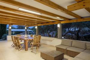 a patio with a table and a couch at Villa 5 elements in Gostinjac