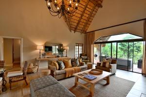 a living room with a couch and a table at Champagne Castle Hotel in Champagne Valley