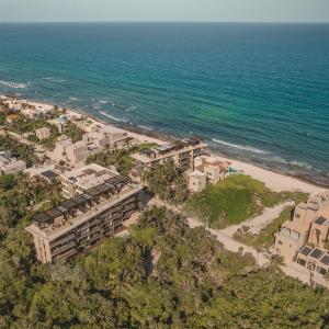 an aerial view of a resort on the beach at Luxury Romantic Getaway - 1 Bedroom - Steps from the Beach - Bahia Tankah Tulum in Tulum
