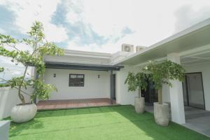 an internal courtyard of a house with two trees at Doña Manor Boutique Hotel in Olongapo