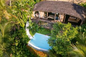 an overhead view of a house with a swimming pool at Ecosix Bali in Tampaksiring
