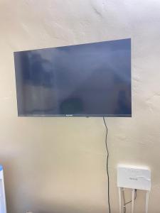 a flat screen tv hanging on a wall at Danfo in Mto Panga