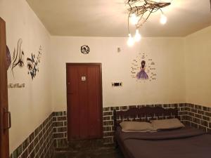 a room with a brick wall and a bed at kMT ooty villa mangal niketen in Ooty +2 photos