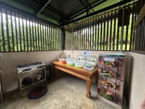 a small kitchen with a table and a stove at FourTwoEight Pai Resort in Kampong Huaibū +40 photos