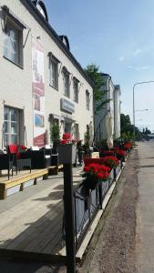a row of benches with flowers on a building at Hotell Östermalm in Motala
