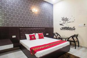 Un dormitorio con una cama grande con almohadas rojas. en Clarks Collection Maanya, en Bareilly 11 fotos más