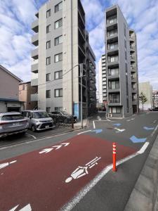 an empty street with a bike lane in a city at Gamadas BLD in Tokyo