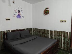 a bed in a bedroom with a wall at kMT ooty villa mangal niketen in Ooty