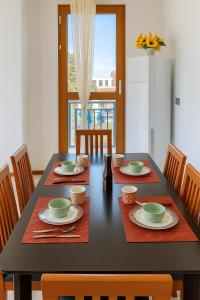 a dining room with a black table and chairs at Alice Apartments near McDonald's Nadi in Nadi