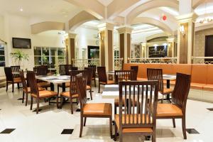 a dining room with tables and chairs in a restaurant at Hotel Trio Indah 2 in Malang