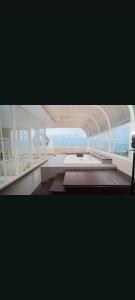 a large room with a table and a view of the ocean at Maison Belle Villa in Tlekung