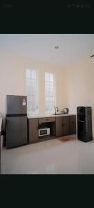 a kitchen with a refrigerator and a counter top at Maison Belle Villa in Tlekung