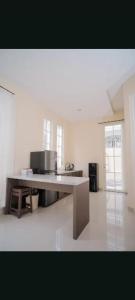 a large kitchen with a table in a room at Maison Belle Villa in Tlekung