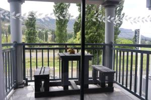 a cat sitting on a table on a balcony with a view at GuestHouseVine&Stone in Clarens