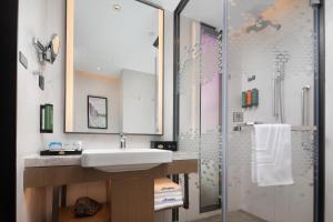 een badkamer met wastafel en douche bij Hilton Garden Inn Chengde Mountain Resort in Niuquanzigou +41 foto's