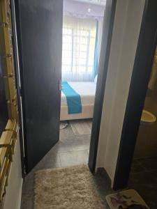 a door leading to a bedroom with a bed at Hami Ventures in Kisumu +1 photo