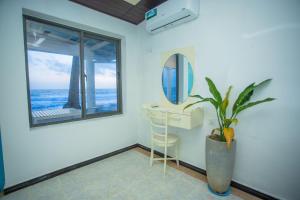 a room with a table and a mirror and a plant at Villa Amor by the Beach in Ambalangoda