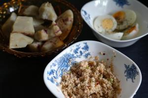 a table with three bowls of food and a bowl of eggs at Sri Vishwa Buddha MUni in Kalagedihena +27 photos