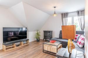 TV a/nebo společenská místnost v ubytování Alsace Moderne - T2 60 m2, terrasse, fibre & Netflix - Niederbronn-les-Bains