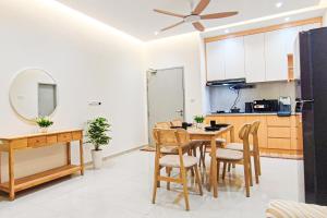 a kitchen and dining room with a table and chairs at Balcony Breeze at Ara Residence Nilai by HCK in Nilai