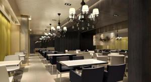 a restaurant with white tables and chairs and chandeliers at Jinjiang Inn Weihai High Speed Qingdao South Road in Weihai